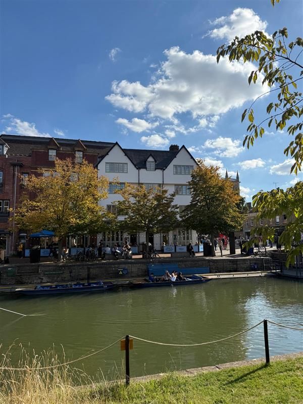 Basing House student accommodation viewed from across the River Cam with punts