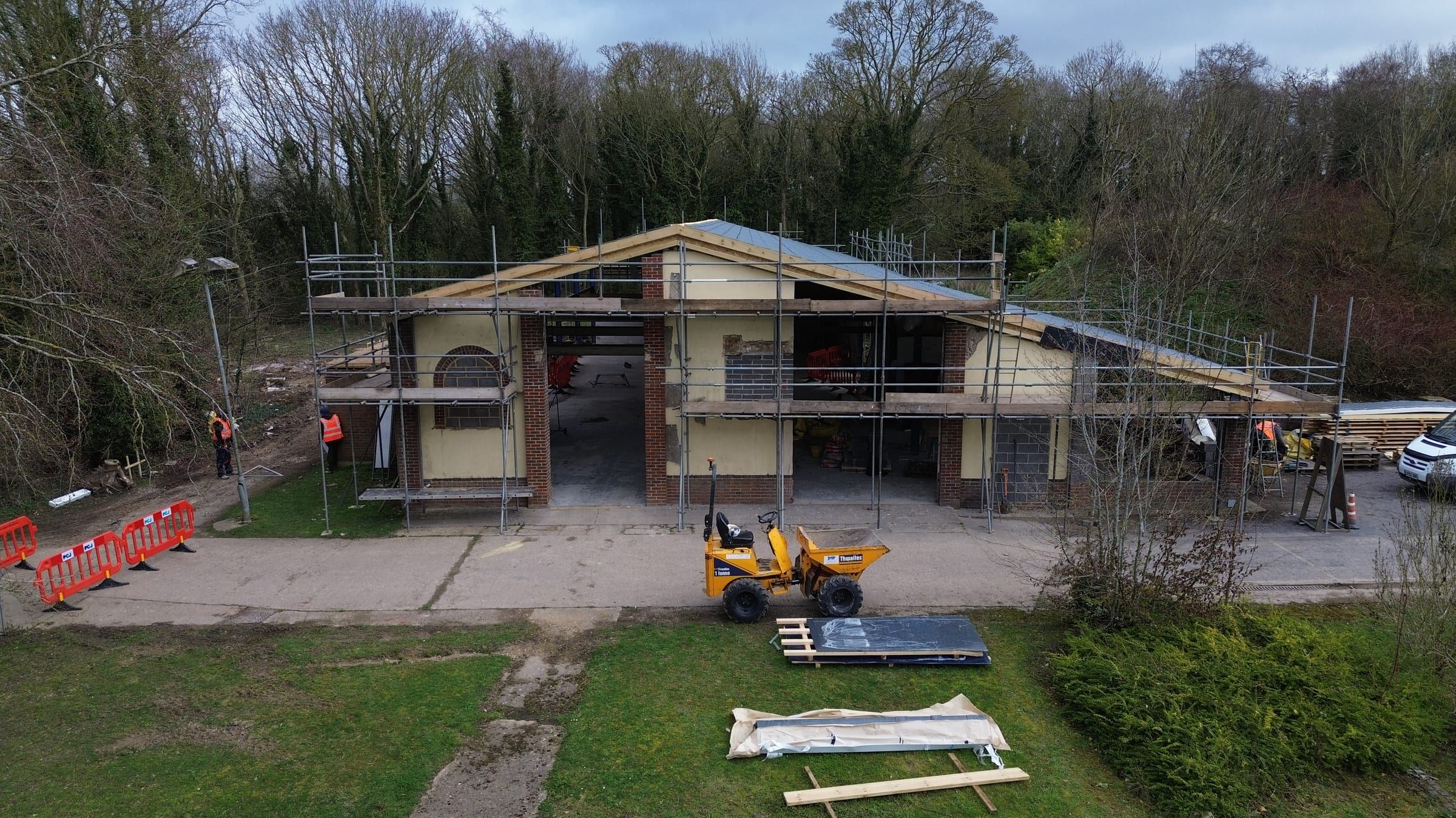 Aerial view of scaffolded barn gable end during structural renovation works