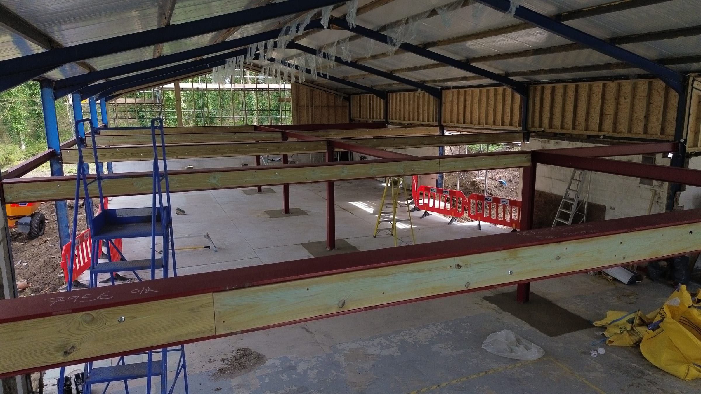 Interior of barn showing steel portal frame and new mezzanine floor structure