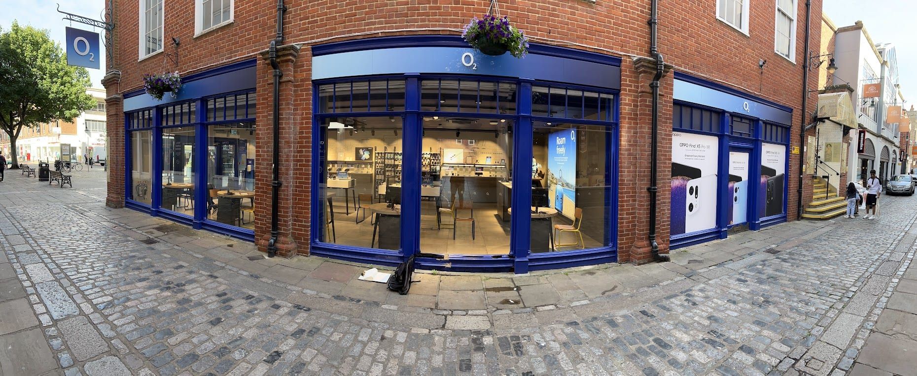 Blue-framed retail shopfront glazing on a brick high street building