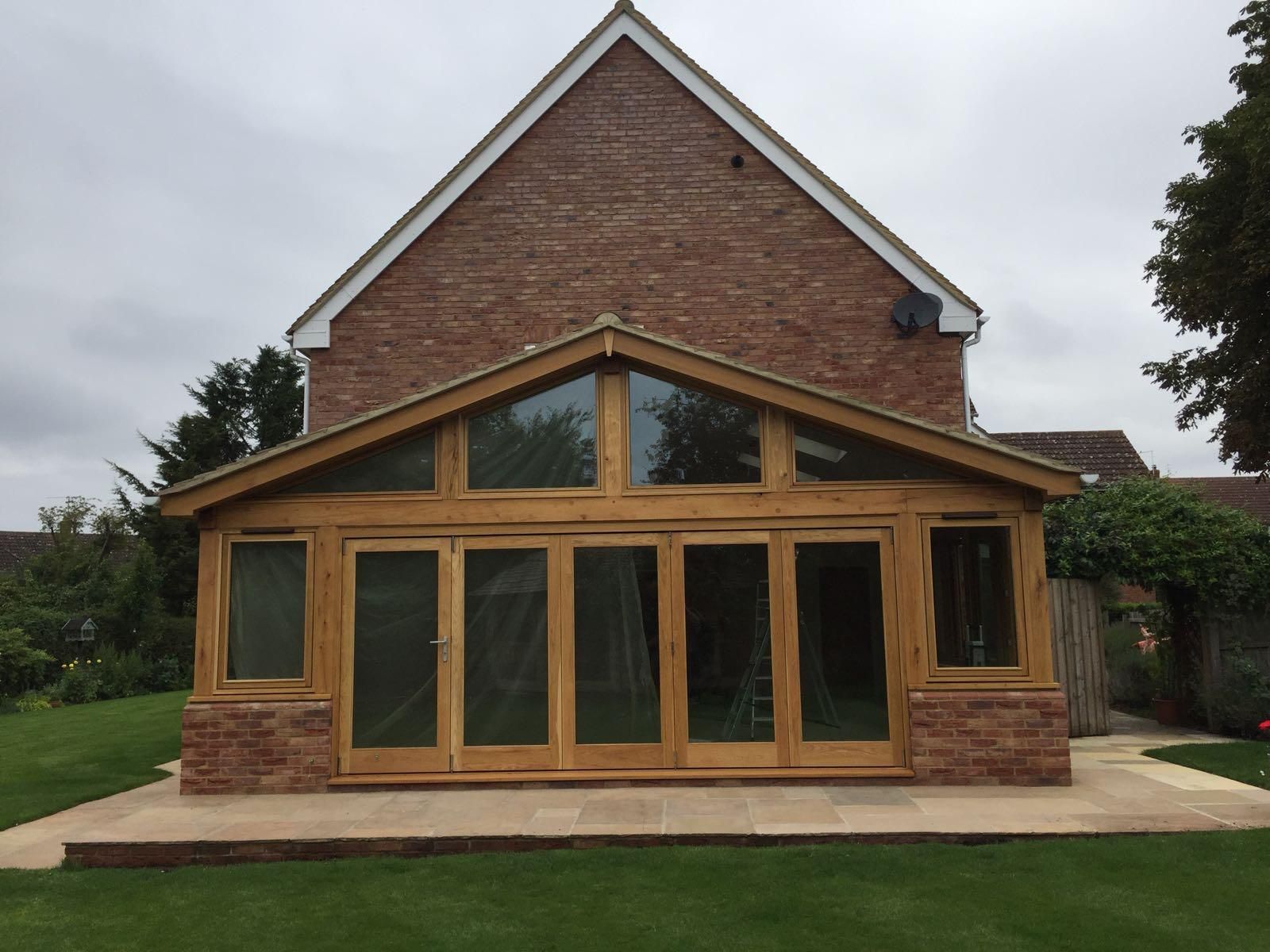 Oak-framed gable extension with full-width bi-fold glass doors