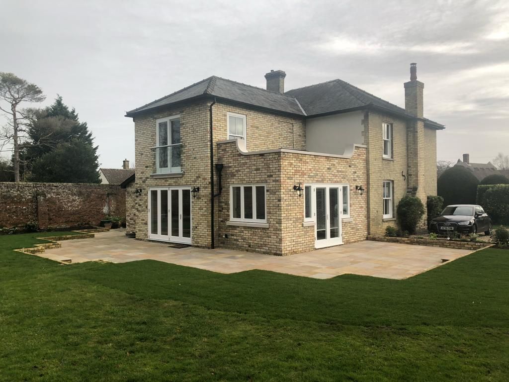 Two-storey brick rear extension with balcony matching the original house