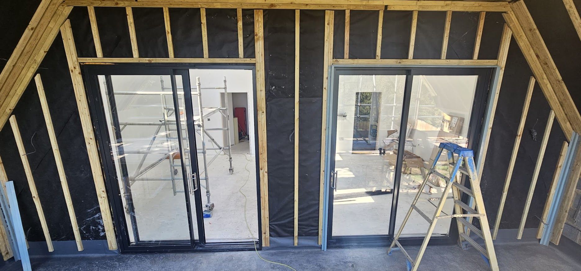 Timber stud framing with bifold door openings ready for glazing