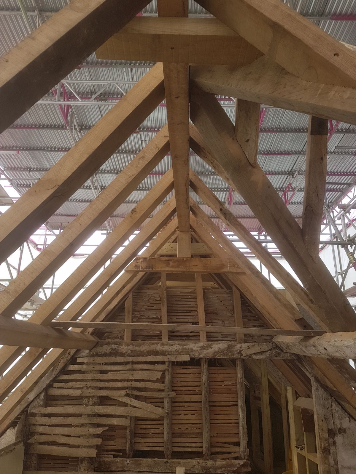 Oak roof frame above exposed wattle and daub gable panel
